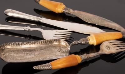 A pair of plated fish servers, a matching