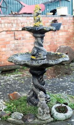 A two-tier fountain with putto finial