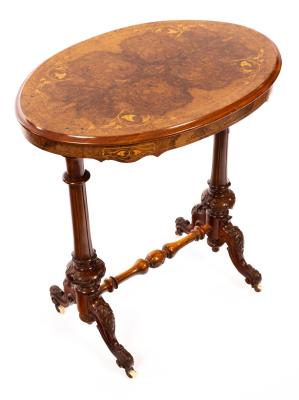 A Victorian walnut table, the oval inlaid