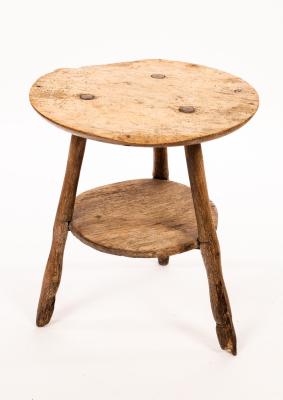 A rustic elm circular cricket table