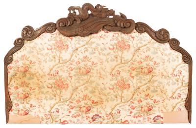 A padded bed head with carved Chinese