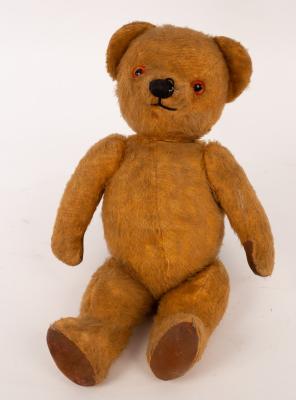 A teddy bear with glass eyes and swivel