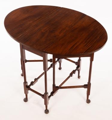 An oval two-flap table on turned legs