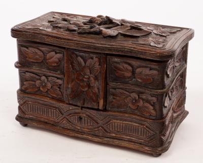 A carved oak jewel box with fitted 2dbe72