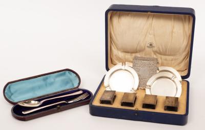 A set of four silver ashtrays and