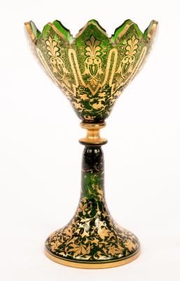 A Victorian green glass vase, cut crenelated