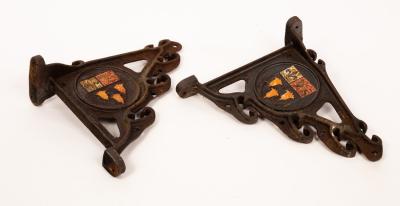 A pair of cast iron wall brackets,