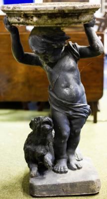 A bird bath with lead putto and dog