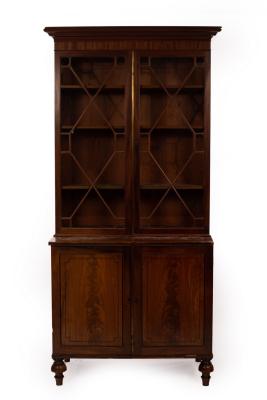 A mahogany bookcase enclosed by a pair