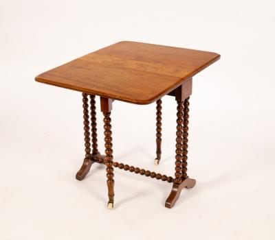 A walnut oval two-flap table on bobbin