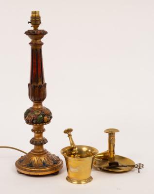 A carved and painted table lamp, a brass