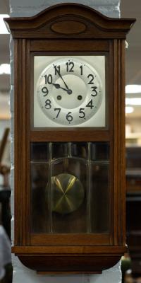 An Edwardian wall clock with silvered