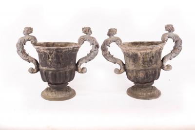 A pair of two-handled lead urns, 48cm