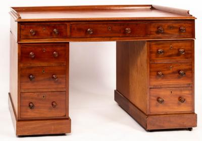 A mahogany pedestal desk with galleried