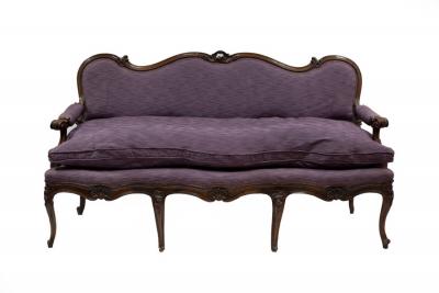 An Italian walnut sofa with carved