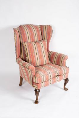 An 18th Century style wingback armchair