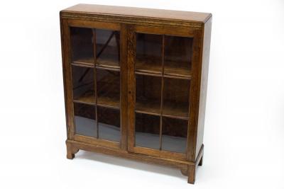 An oak bookcase enclosed by glazed panel