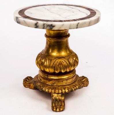 A low marble top table on carved