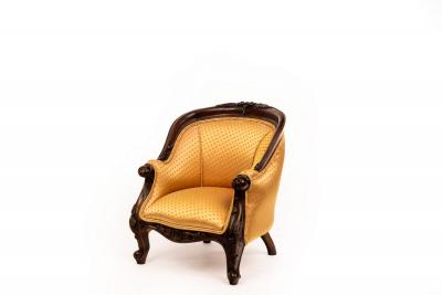 A childs upholstered tub armchair