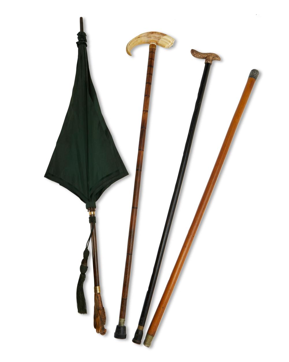 A GROUP OF CANES AND ONE UMBRELLAA