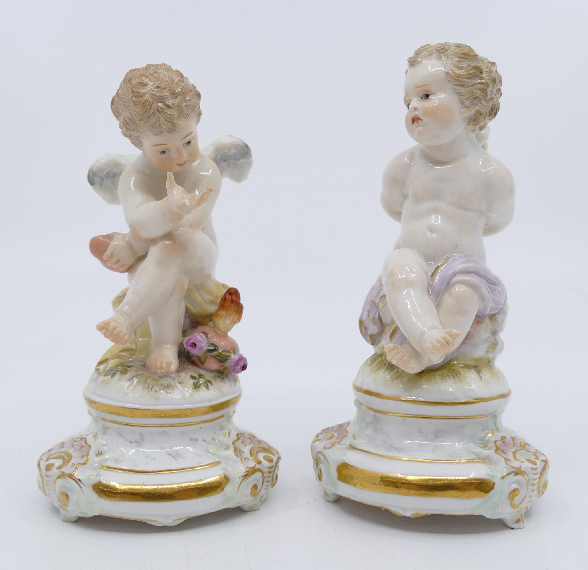 Pair Meissen Cupid Porcelain Figurines.