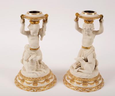 A pair of glazed and biscuit porcelain