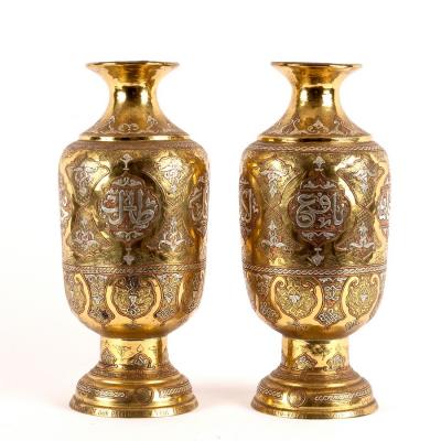 A pair of Eastern brass baluster vases,