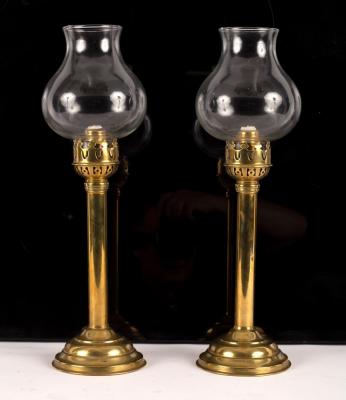 A pair of brass spring loaded candlesticks