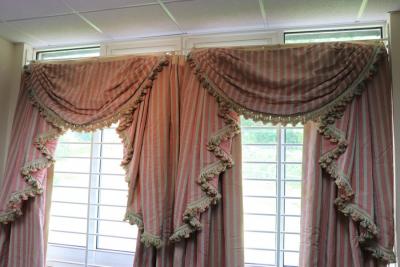 A pair of pink, moire stripe curtains,