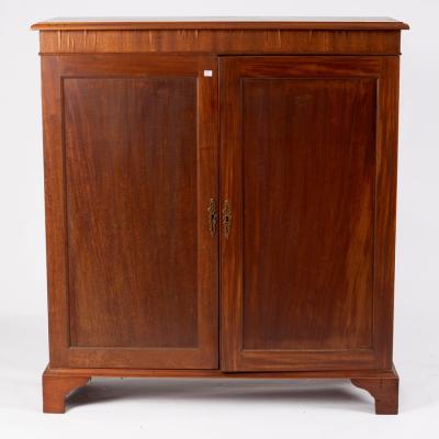 A mahogany cupboard enclosed by a pair