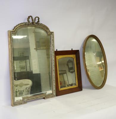 A gilt framed wall mirror with ribbon