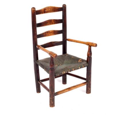 A child's ladder back chair with