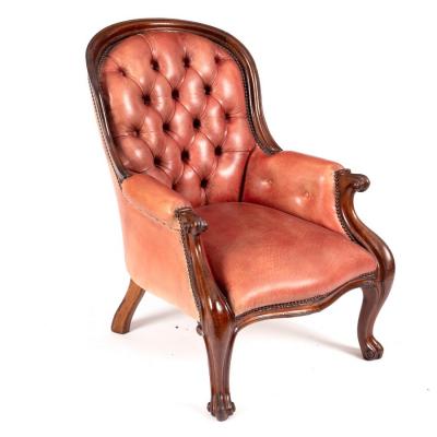 A Victorian button back easy chair upholstered