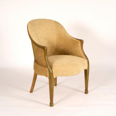A tub armchair upholstered in pale