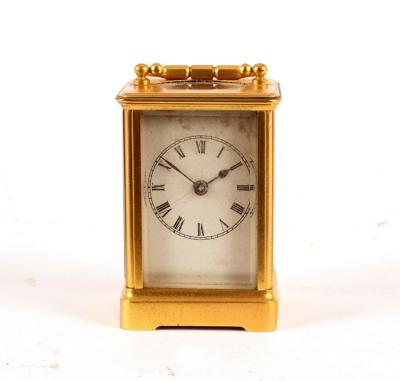 A small carriage clock in a gilt brass