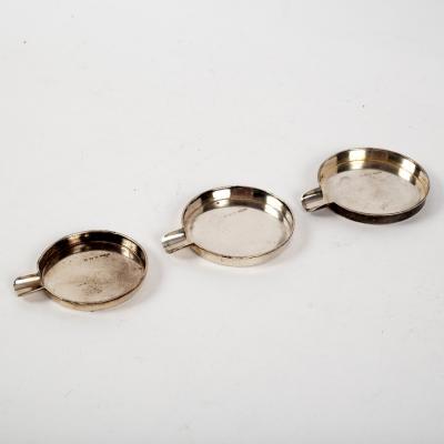 A nest of three graduated silver ashtrays,