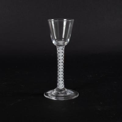 An 18th Century cordial glass on a cotton