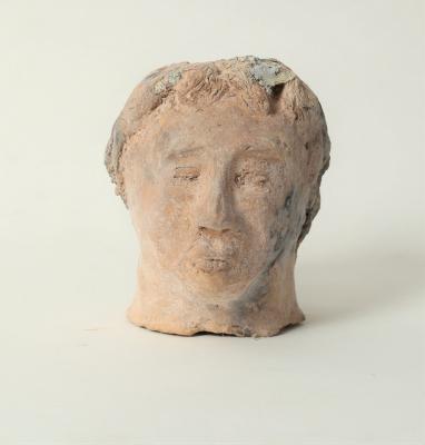 A pottery model of a male head,