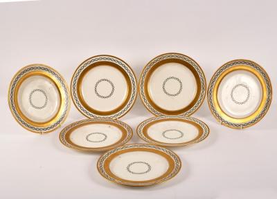 Seven Minton plates with gilt borders