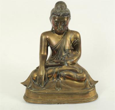 An Eastern bronze figure of a seated