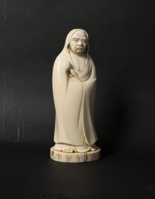 A Japanese carved ivory okimono of Daruma,