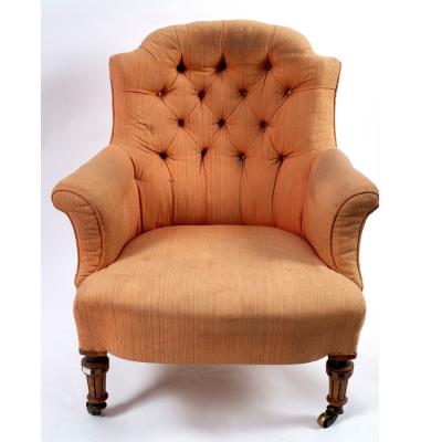 A Victorian button back armchair on