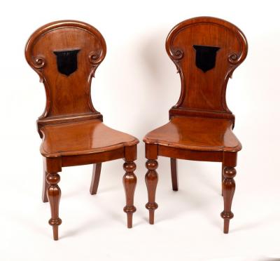 A pair of Victorian mahogany hall chairs,