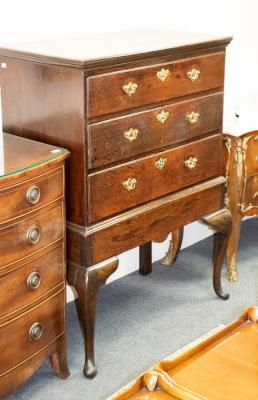 A Georgian oak chest of three drawers,