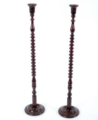 A pair of beech candlesticks with bobbin