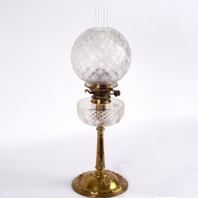 A brass and glass oil lamp with funnel,