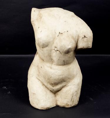 A plaster bust of a nude female torso,