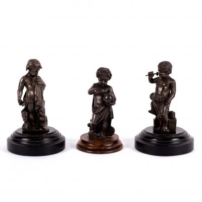 Three bronze figures of putti, perhaps