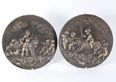 A silvered pair of cast metal roundels