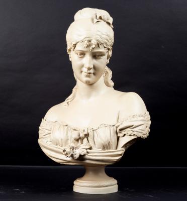 A resin bust of a young woman, signed